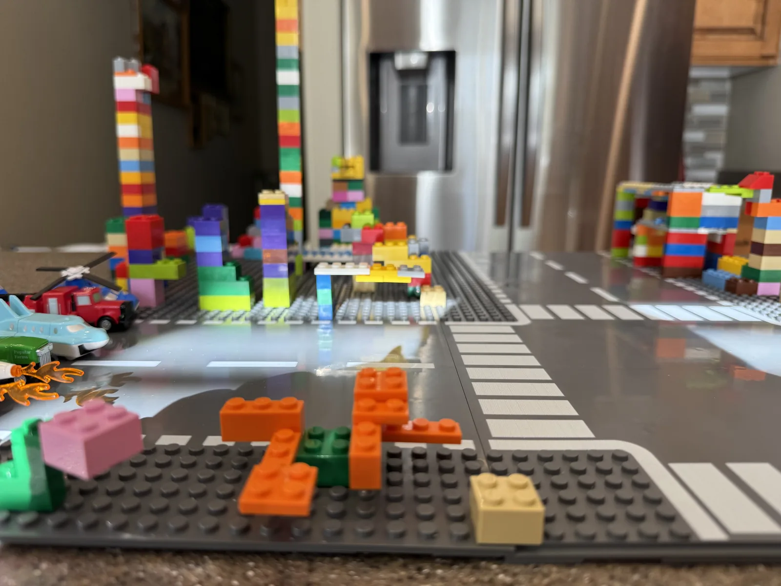 A massive brick city is built on the Slab Dream Lab gray baseplate pack toy.